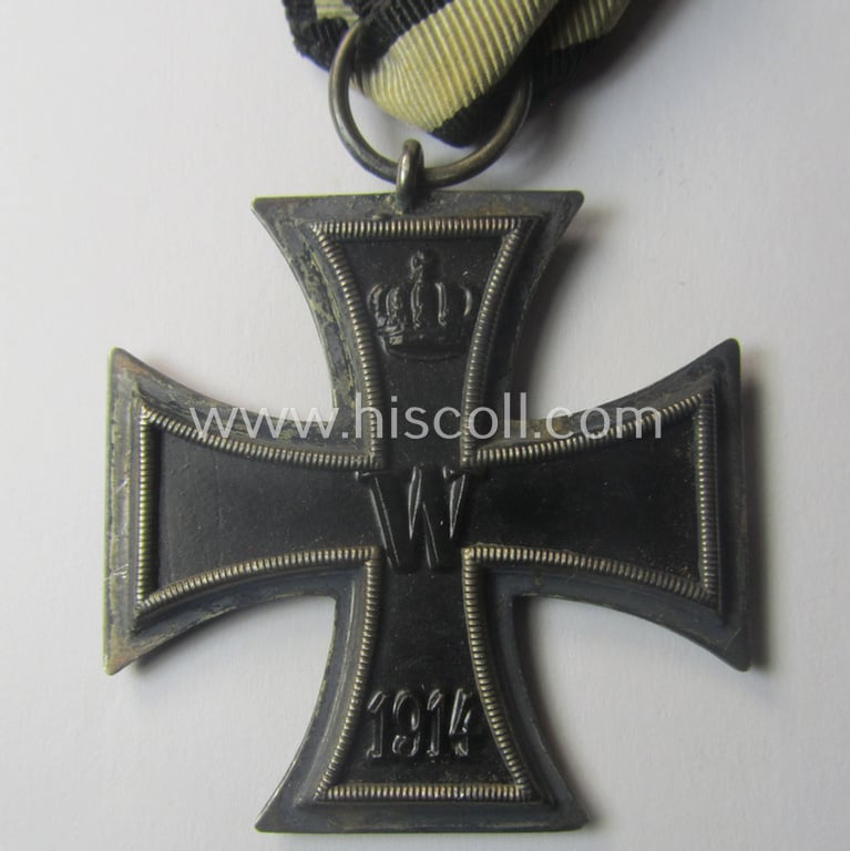WWI-period: 'Eisernes Kreuz II. Klasse' being a typical maker- (ie. 'K.A.G.'-) marked example that comes mounted onto an unusually confectioned ribbon