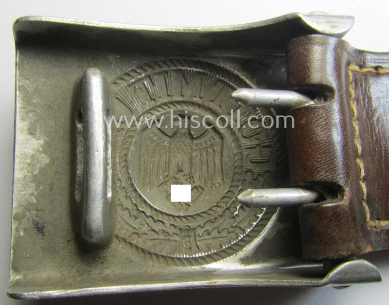 WH (Heeres) 'standard-pattern', field-grey-toned- and aluminium-based belt-buckle being a maker- (ie. 'Gebr. Gloerfeld'-) marked- and/or '1938'-dated example that comes mounted onto its leather-based tab