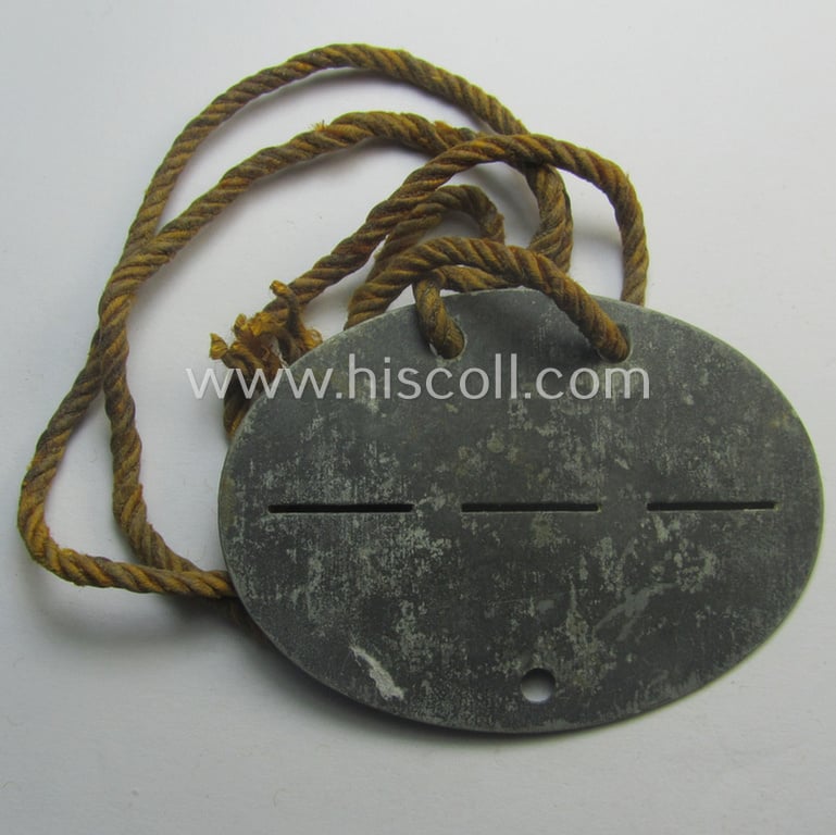 Zinc-based, WH (LW) ie. 'Flieger'-related ID-disc bearing the clearly stamped unit-designation that simply reads: '12. Flg.Rgt. 53' (and as such belonging to a staff-member serving within the: 'Luftgau-Feld-Regiment Belgien-Nordfrankreich')