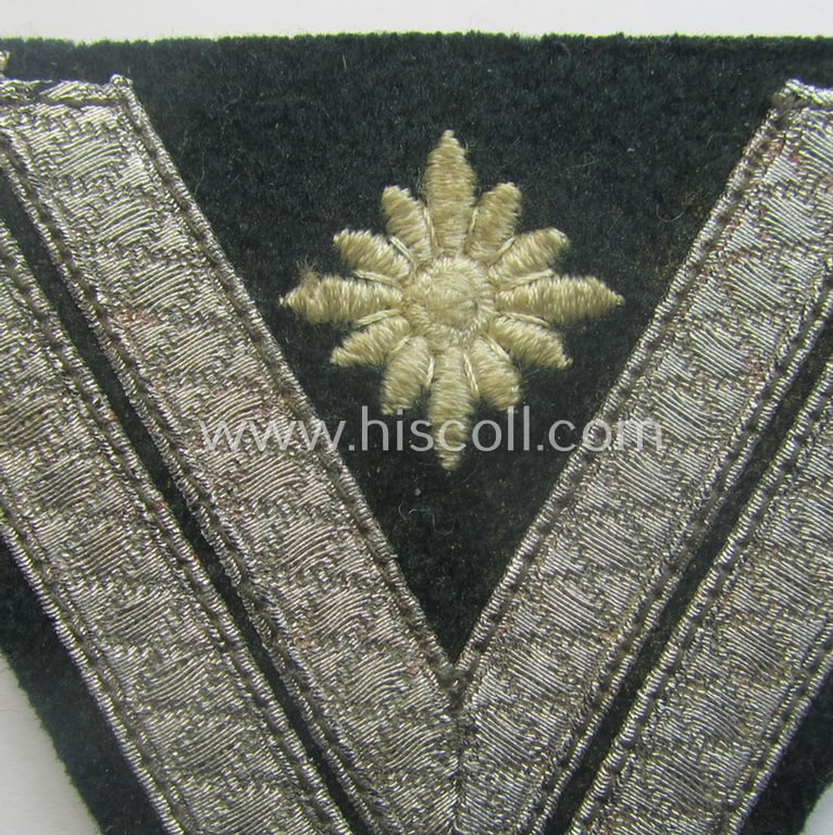 WH (Heeres) 'Armwinkel' (or: arm-chevron) as executed on typical darker-green-coloured wool as was specifically intended for usage by a soldier with the (unusually encountered!) rank of: 'Stabsgefreiter'