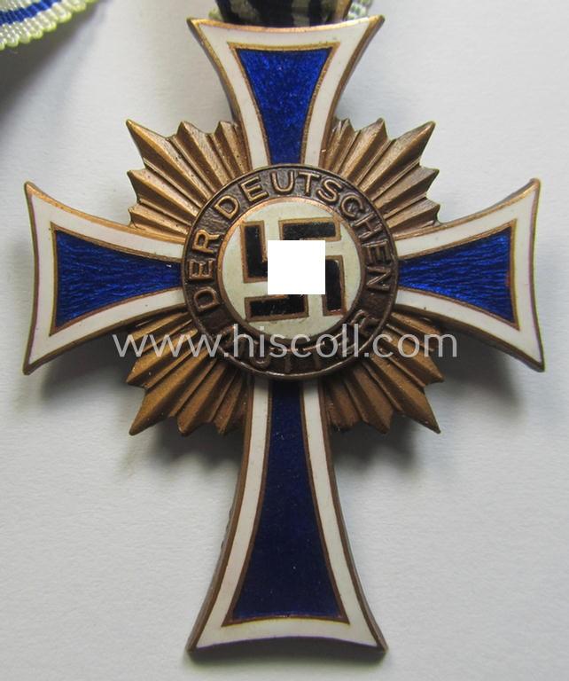 Neat, 'Ehrenkreuz der deutschen Mutter - dritte Stufe' being a non-maker-marked example that comes mounted onto its (large-sized!) ribbon and that comes in an overall very nice- (albeit minimally worn- ie. used-), condition