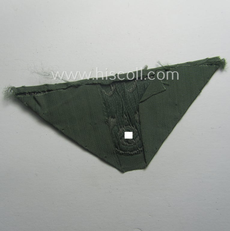 Truly used and cap-removed, early- (ie. mid-) war-period WH (Heeres) cap-eagle (ie. 'Schiffchenmützen-Adler für Mannschaften u. Uffz.') being a trapezoid-shaped example as executed in bluish-grey-coloured linnen on a field-grey-coloured background