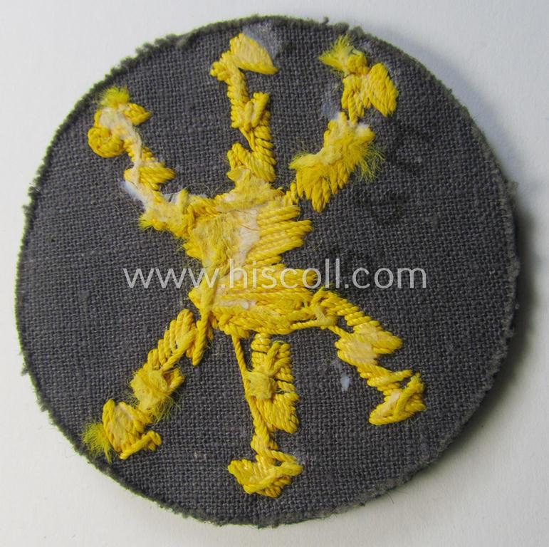 Attractive, WH (Heeres) so-called: trade- and/or special career arm-insignia as was intended for a: 'Funkmeister' being a neatly hand-embroidered (and maker-marked) specimen on a darker-green-coloured woolen-based background