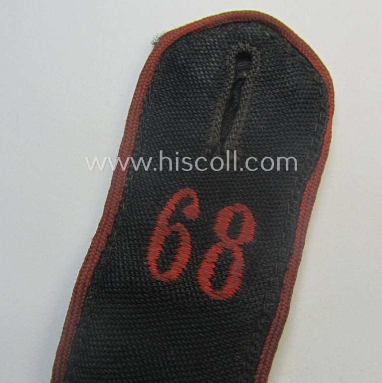 Moderately worn - albeit regrettably single! - bright-red-piped so-called: 'Allgemeine-HJ'-shoulderstrap as intended for an: 'HJ-Scharführer' who served within the 'Bann 68' (68 = 'Bann Maifeld' situated in the 'Gebiet West Westmark')