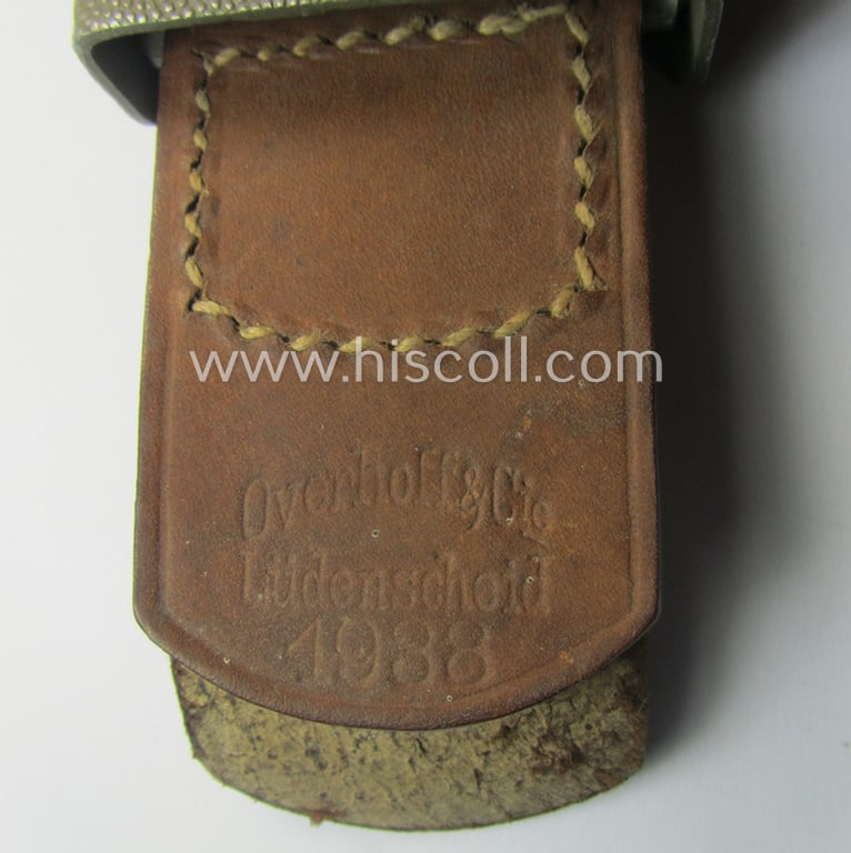 Superb, WH (Heeres) 'standard-pattern', field-grey-toned- and aluminium-based belt-buckle being a maker- (ie. 'Overhoff & Cie.'-) marked- and/or: '1938'-dated example that comes mounted onto its leather-based tab