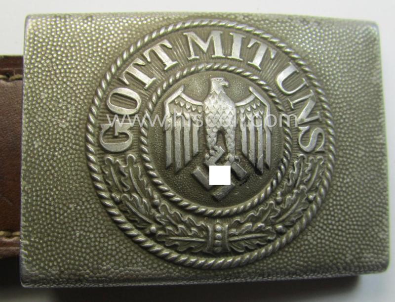 WH (Heeres) 'standard-pattern', field-grey-toned- and aluminium-based belt-buckle being a maker- (ie. 'Gebr. Gloerfeld'-) marked- and/or '1938'-dated example that comes mounted onto its leather-based tab