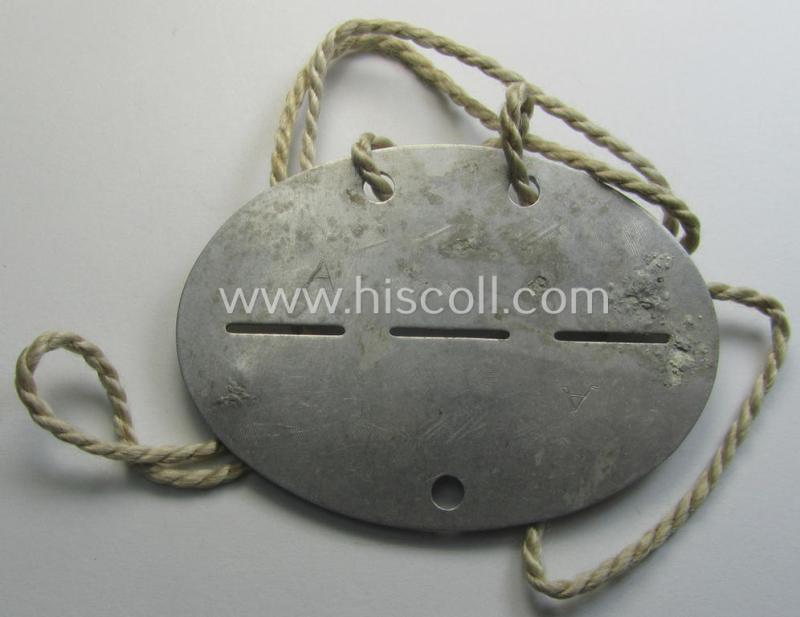 Aluminium-based, WH (Heeres) (ie. 'Pz-Abwehr'-related) ID-disc bearing the clearly stamped unit-designation that reads: '2 / Panz. Abw. Abt. 254' and that comes still mounted onto its (period-attached) cord