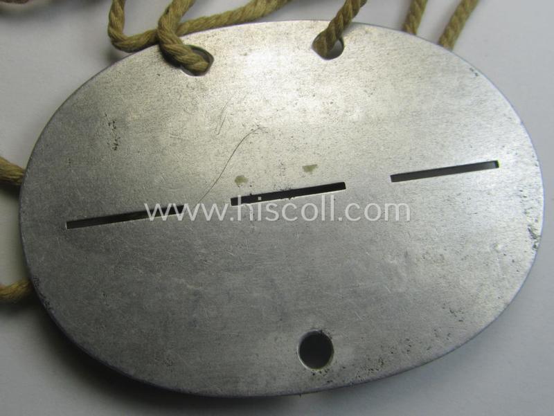 Aluminium-based, WH (Heeres) ie. 'Infanterie-Truppen'-related ID-disc bearing the clearly stamped unit-designation: '1. Schtz.Felders.Kp. 23' and that comes mounted onto its period cord as issued and worn