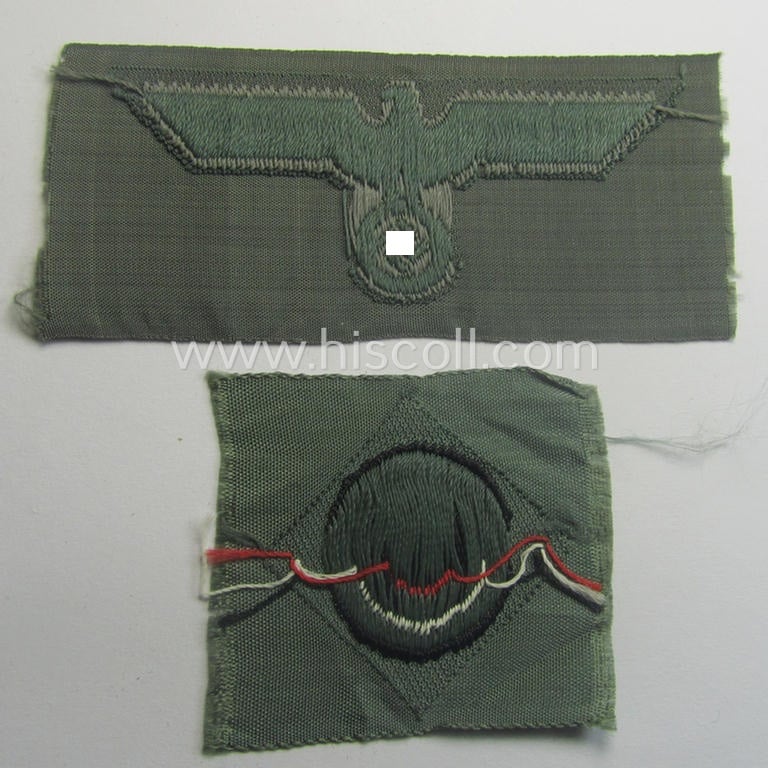 Early- (ie. mid-) war-period, WH (Heeres) cap-eagle & cocarde-set (ie. 'Schiffchenmützen-Adler u. Kokarde-Satz für Mannschaften u. Uffz.') being a 'virtually mint' set as executed in bluish-grey-coloured linnen on a field-grey-coloured background