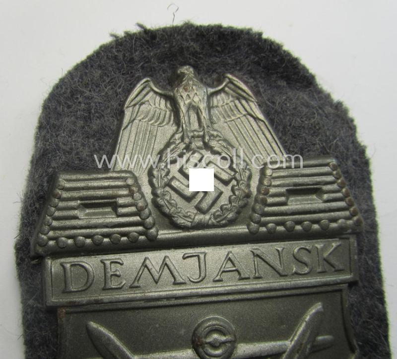 WH (Luftwaffe) 'Demjansk'-campaign-shield as executed in typical magnetic metal (ie. so-called: 'Eisenblech') and that comes in an overall nice- (ie. most certainly worn but nevertheless ie. fully untouched!), condition