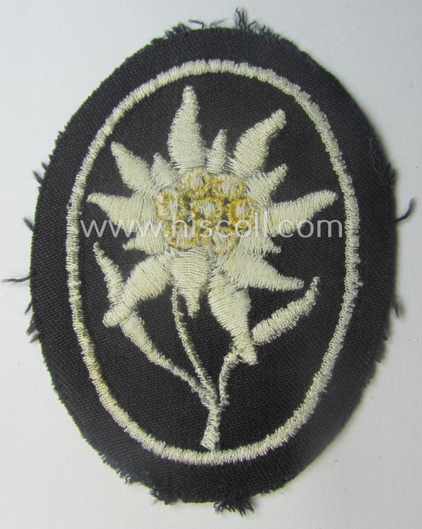 Waffen-SS-pattern, black-coloured sleeve-insignia (ie. 'Ärmelabzeichen') depicting an: 'Edelweiss'-flower as used by the various 'Gebirgsjäger'- (ie. mountain-troops-) related divisional-staff