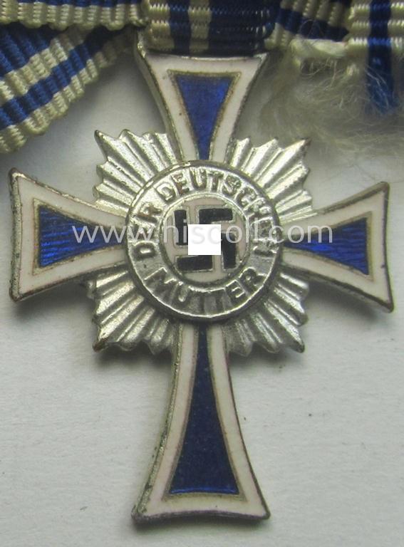 Miniature of an: 'Ehrenkreuz der deutschen Mutter - zweite Stufe' (or: silver-class mothers'-cross) being a non-maker-marked example that comes in an overall nice- (albeit moderately worn- ie. used-), condition