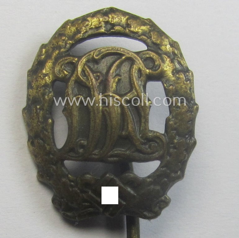 'Reichssportabzeichen DRL in Bronze' (or: bronze class DRL sports'-badge) being a maker- (ie. 'Ernst L. Müller'-) marked and that comes with its accompanying miniature