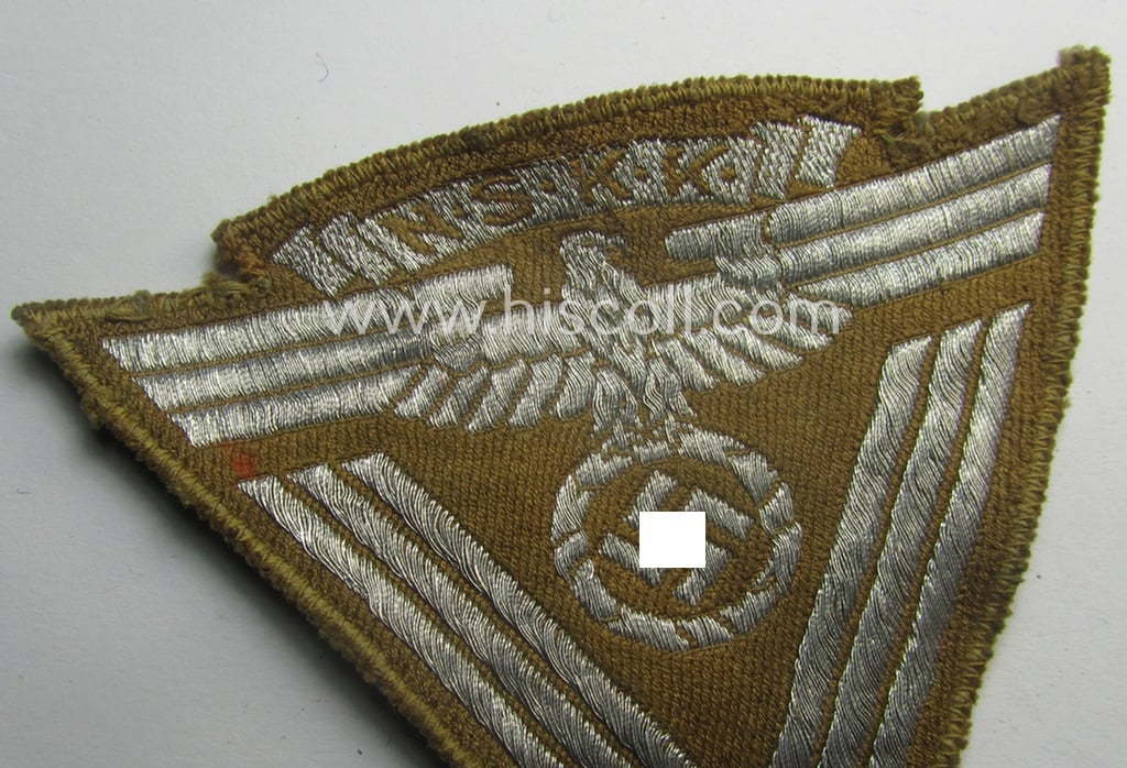 Attractive, so-called: N.S.K.K. (ie. 'National Socialistisches Kraftfahr Korps') arm-eagle (showing a combined arm-eagle and/or chevron) as executed in so-called: flatwire, 'BeVo'-weave pattern and comes mounted onto a beige-coloured background