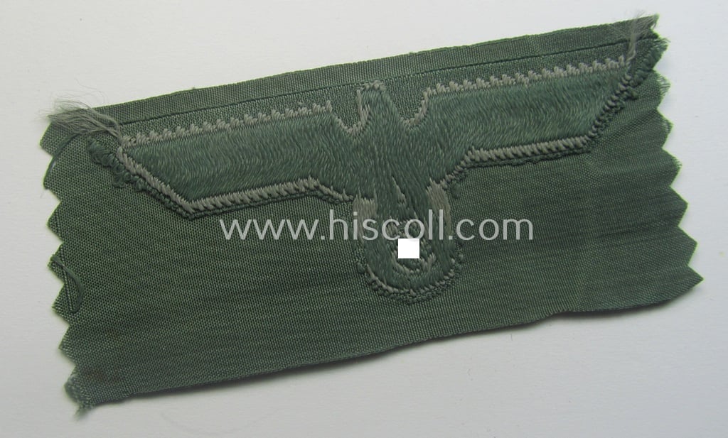 Early- (ie. mid-) war-period, WH (Heeres) cap-eagle & cocarde-set (ie. 'Schiffchenmützen-Adler u. Kokarde-Satz für Mannschaften u. Uffz.') being a 'virtually mint' set as executed in bluish-grey-coloured linnen on a field-grey-coloured background