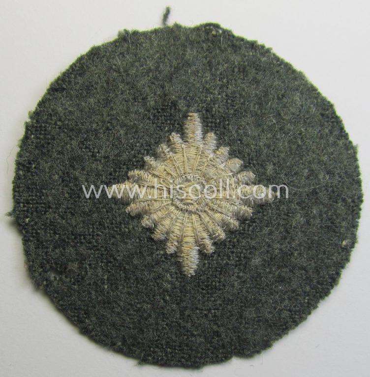 WH (Heeres) rank-insignia (ie. silver-grey-coloured and machine-embroidered 'roundel') as intended to identify a soldier with the rank of: 'Oberschütze', 'Oberjäger' etc. that comes in a clearly used- and/or tunic-removed, condition