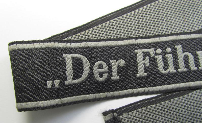 Stunning, Waffen-SS, 1943-pattern cuff-title (ie. 'Ärmelstreifen') depicting the machine-woven Latin script text in silver-grey linnen, as was intended for a member of the: 'SS-Regiment “Der Führer”