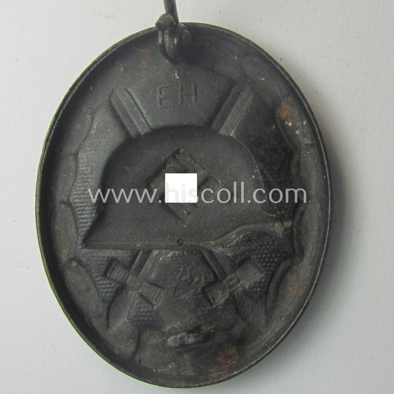 Dual-maker- (ie. 'E.H.'- and/or: '126'-) marked example of a black-class wound-badge (or: 'Verwundeten-Abzeichen in Schwarz') being an example that was produced by the maker (ie. 'Hersteller') named: 'Eduard Hahn'