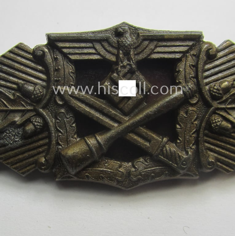 'Nahkampfspange in Bronze' (or: bronze-class close-combat clasp ie. CCC) being a (typical) non-maker-marked- and/or minimally converse-shaped specimen as was (I deem) produced by the maker- (ie. 'Hersteller') 'Steinhauer & Lück'