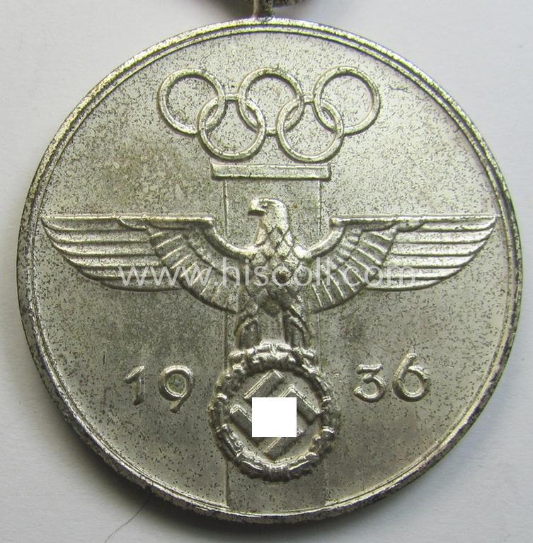 Superb, 'Deutsche Olympia-Erinnerungsmedaille 1936' being a non-maker-marked example that comes mounted onto its original ribbon (ie. 'Bandabschnitt') and that comes stored in its typical, beige-white-coloured etui as issued and stored for decade...