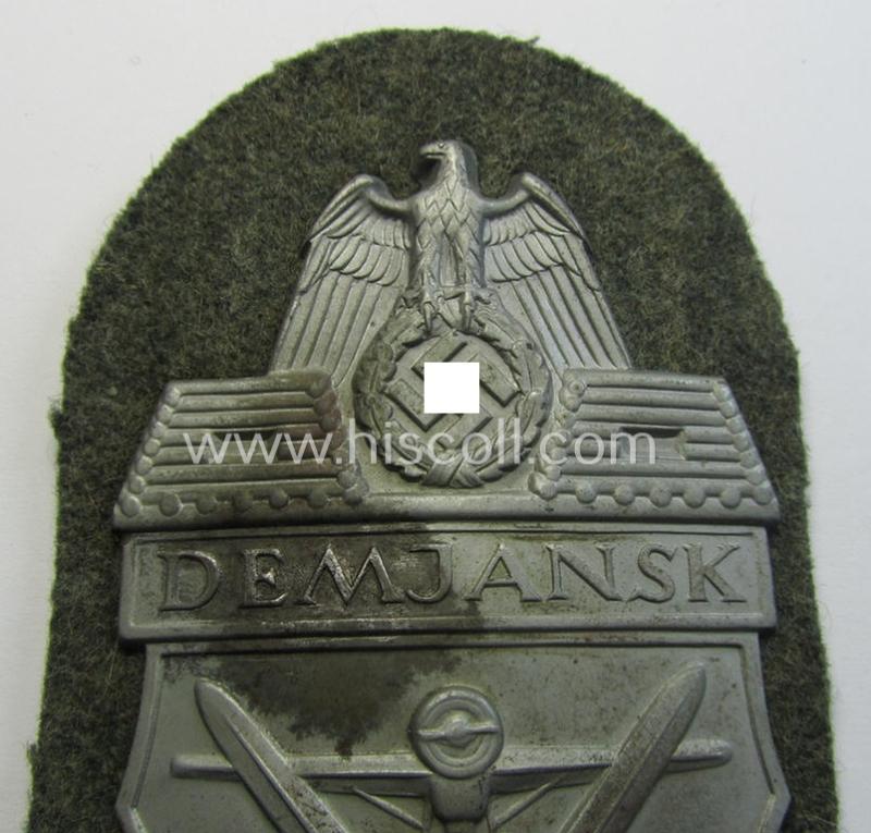 WH (Heeres ie. Waffen-SS) 'Demjansk'-campaign-shield as executed in typical magnetic metal (ie. so-called: 'Eisenblech') and that comes in an overall very nice- ie. fully untouched, condition