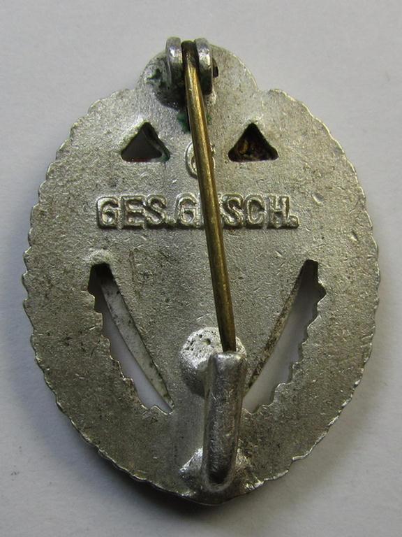 Honorary-membership lapel-pin (aka: 'Silberne Ehrennadel für 25 Jahre Mitgliedschaft im Nationalsocialistischer Reichskriegerbund' (ie. 'N.S.R.K.B.') being a maker- (ie. '6'-) marked example that also bears a: 'Ges.Gesch.'-designation on its...