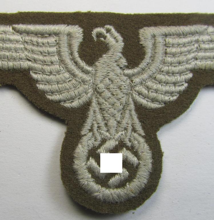 Attractive, machine-embroidered arm-eagle (ie. 'Ärmeladler') as was specifically intended for usage on the brownish-green-coloured tunics of officials of the: 'Reichsministerium für besetzte Ostgebiete' (ie. 'R.M.b.O.')