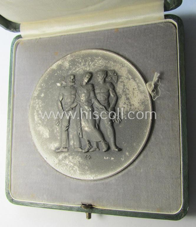 Larger-sized- and silver-toned, so-called: award-plaque (or: 'Erinnerungs- o. nichttragbare Medaille') showing 3 figures and that is entitled: 'Für langjährige Mitarbeit im Dienste der Pfälzischen Wirtschaft' and that comes stored in its period-e...