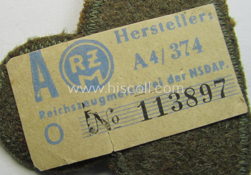 Attractive, greenish-tan-coloured, so-called: N.S.K.K. (ie. 'National Socialistisches Kraftfahr Korps') arm-eagle, still having its original-applied- and/or paper-based 'RzM'-etiket attached