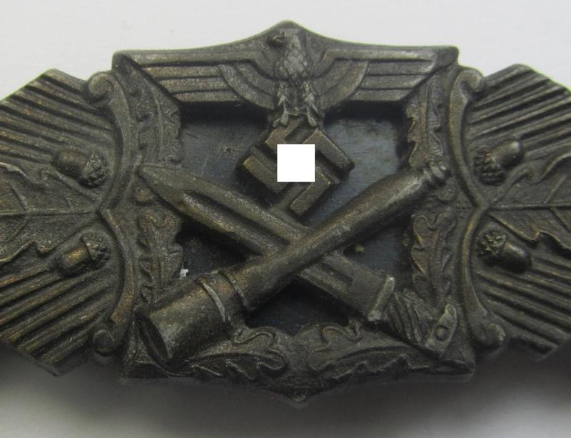 'Nahkampfspange in Bronze' (or: bronze-class close-combat clasp ie. CCC) being a neatly maker-marked- and/or minimally converse-shaped specimen as was produced by the: 'JFS'- (ie. 'Joseph Feix u. Söhne'-) company