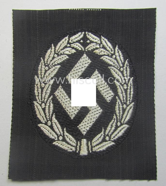 EM- (ie. NCO-) type, so-called: 'Schutzmannschaften' (or: 'Schuma') cap-badge as executed in greyish-coloured thread onto a black-coloured- (ie. 'SS-Polizei'- ie. 'SD'-related-) background
