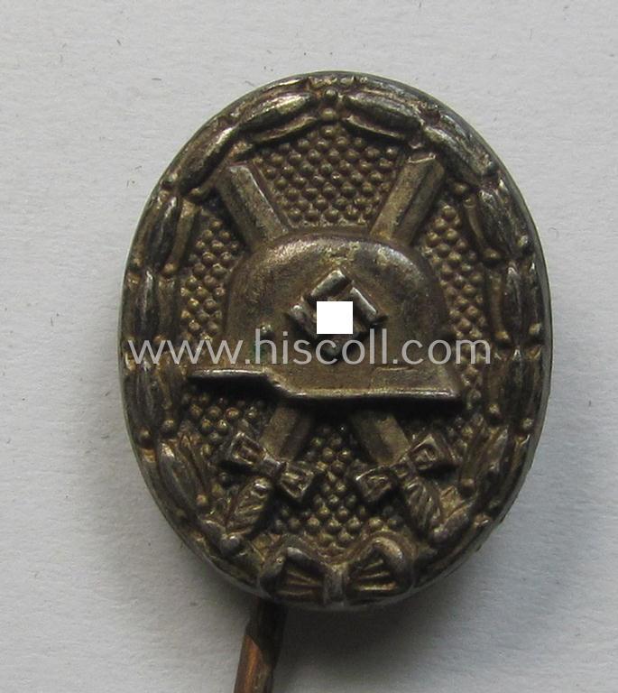 Neat - and 17 mm. sized! - miniature lapel-pin (ie. 'Halbminiatur') depicting a: 'Verwundeten-Abzeichen in Silber' (or: silver-class wound-badge) being a maker- (ie. 'L/54'-) marked example as executed in silver-coloured metal