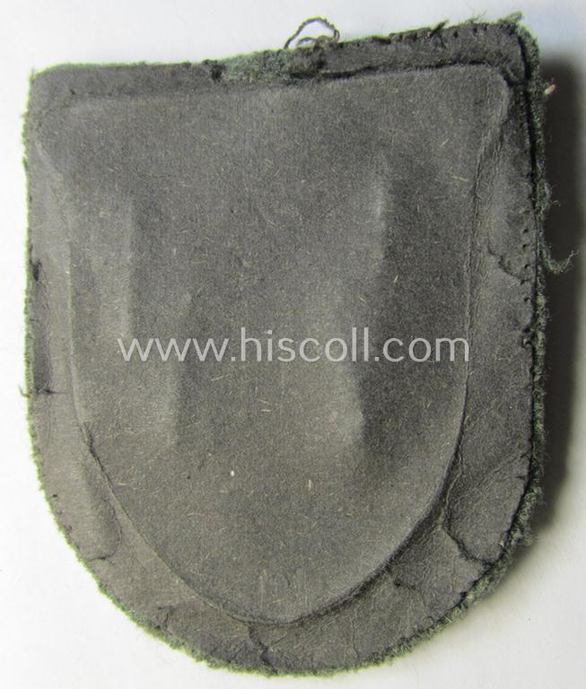 Attractive, WH (Heeres o. Waffen-SS) 'Krim'-campaign-shield that comes mounted onto its original, field-grey-coloured 'backing' and that comes in a surely issued-, minimally worn and/or (I deem) carefully tunic-removed-, condition