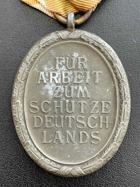 WWII GERMAN WEST WALL MEDAL WITH PAPER ISSUE PACKET.