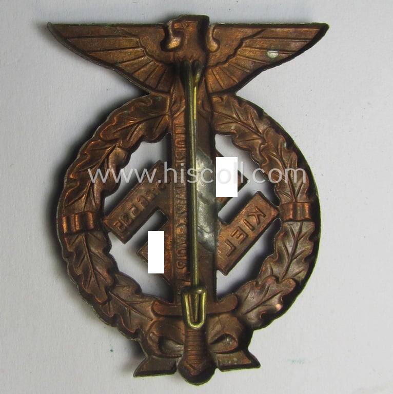 Commemorative, reddish-copper-coloured- and/or tin-based, N.S.D.A.P.- (ie. SA-) related 'tinnie' being a non-maker-marked example depicting an upward-positioned sword, swastika and text that reads: 'Nordmark Voran - Kiel - 25.26.5.1935'