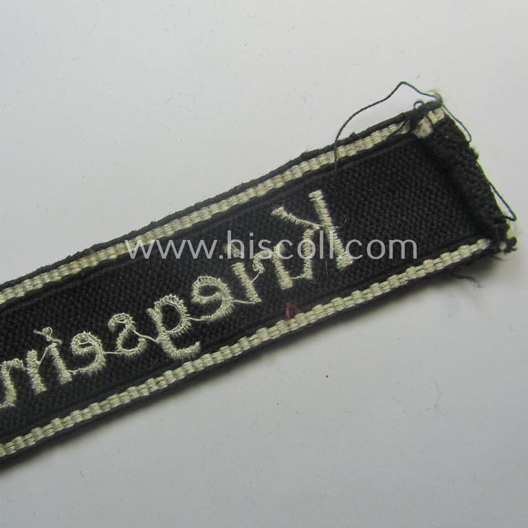 Superb - and actually never before encountered! - example of a HJ/BDM- ('Hitlerjugend' ie. 'Bund Deutscher Mädel'-) cuff-title (ie. 'Ärmelstreifen') entitled: 'Kriegseinsatzführer' being an example as executed in the machine-embroidered pattern