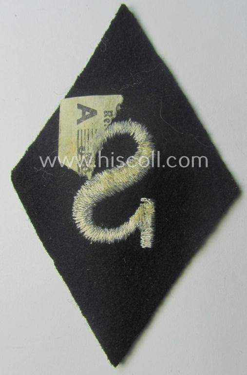 Waffen-SS-pattern, machine-embroidered and black-coloured sleeve-insignia (ie. 'Ärmelraute') depicting a captital: 'S'-character as was used to signify the function of: 'Schirrmeister' within the: 'Waffen-SS'