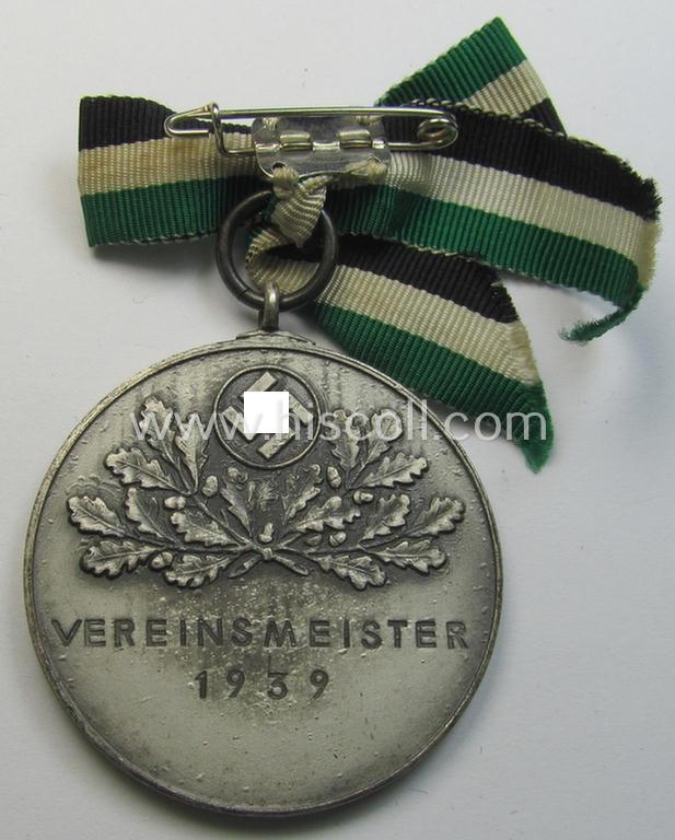 Superb - and most certainly unusually seen! - frosted-silver-toned, TR-period shooting-medal showing on its front a uniformed hunter and that is entitled: 'Vereinsmeister 1939' and that comes mounted onto its 'bow-tie-shaped' ribbon as issued