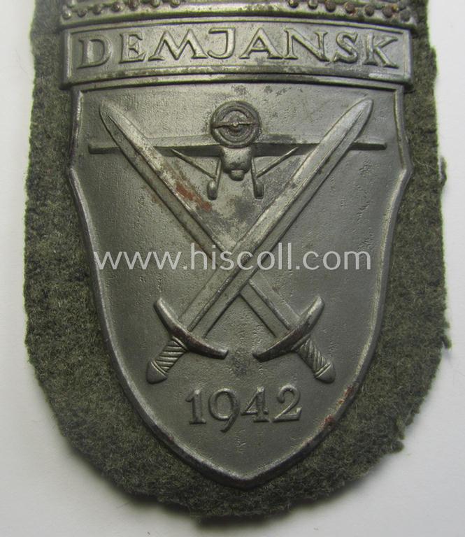 WH (Heeres ie. Waffen-SS) 'Demjansk'-campaign-shield as executed in typical magnetic metal (ie. so-called: 'Eisenblech') and that comes in an overall very nice- ie. fully untouched, condition