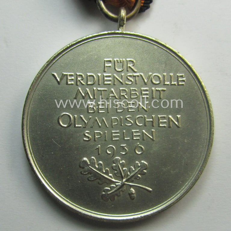 'Deutsche Olympia-Erinnerungsmedaille 1936' being a non-maker-marked example that comes mounted onto its original ribbon (ie. 'Bandabschnitt')