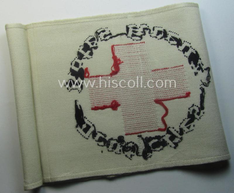 Linnen-based- and/or neatly 'machine-embroidered', beige-white-coloured DRK- (ie. 'Deutsches Rotes Kreuz'-) armband (ie. 'Armbinde') as was intended for the staff-members serving with the: 'Deutsches Rotes Kreuz' (or: German Red Cross)