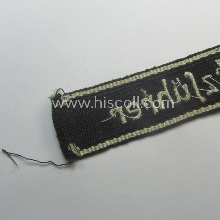 Superb - and actually never before encountered! - example of a HJ/BDM- ('Hitlerjugend' ie. 'Bund Deutscher Mädel'-) cuff-title (ie. 'Ärmelstreifen') entitled: 'Kriegseinsatzführer' being an example as executed in the machine-embroidered pattern