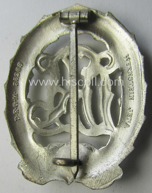 'Virtually mint' example of a: 'Reichssportabzeichen DRL in Silber' (or: DRL sports'-badge in silver) being a just moderately worn- ie. used example that is nicely maker- (ie. 'Wernstein - Jena'-) marked on its back