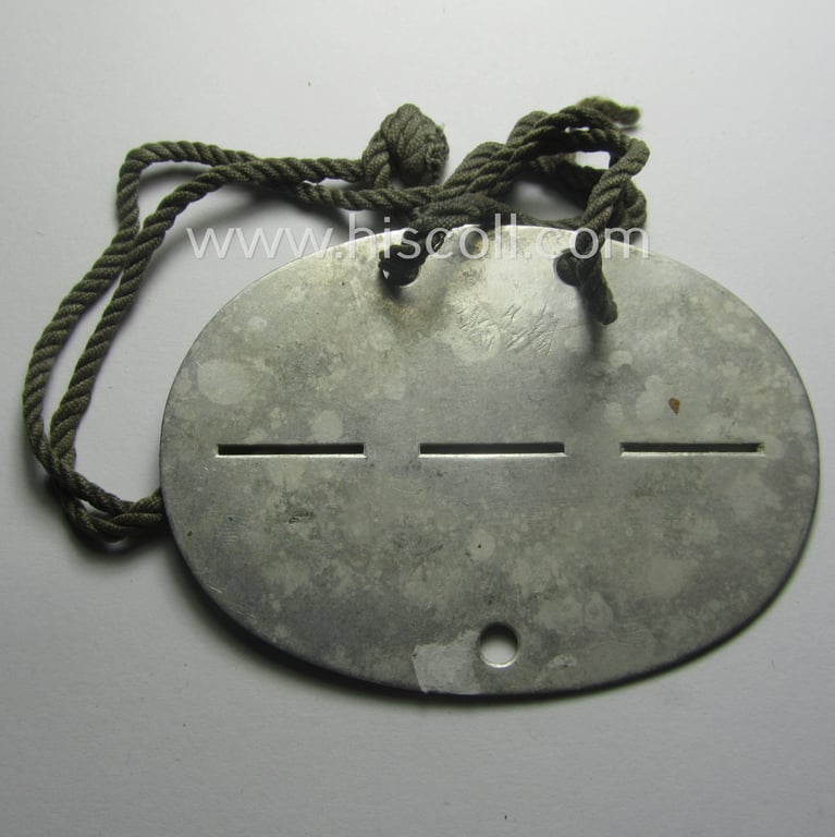 Neat, aluminium-based WH (Heeres) ID-disc (ie. 'Erkennungsmarke') bearing the clearly stamped unit-designation: 'St.Kp./Lds.Schtz.Ers.Btl. 14' (being a disc as intended for a soldier that served within the: 'Landesschützen-Ersatz-Battailon 14')