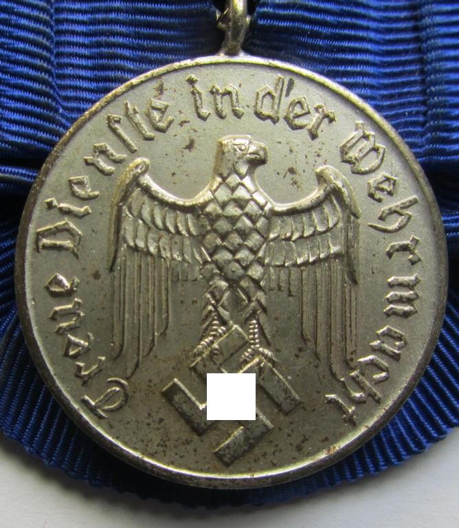 Attractive, silver-toned WH (Heeres o. KM) so-called: 'Einzelspange' showing a: 'WH-Dienstauszeichnung 4. Stufe' (as was intended for 4 years of loyal-service) and that shows a detailed, Heeres o. KM-type-eagle-device, period-attached