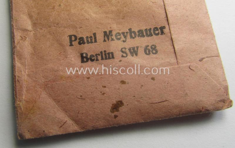 'Kriegsverdienstmedaille 1939'-set comprising of a non-maker-marked- (and/or: typical 'Buntmetall'-based!) specimen that came together with its period-ribbon and 'Zellstoff'-based pouch by the maker: 'Paul Meybauer'