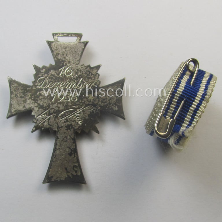'Ehrenkreuz der deutschen Mutter - zweite Stufe' (or: silver-class mothers'-cross) that came together with its 'rolled-up' ribbon as issued and recently found