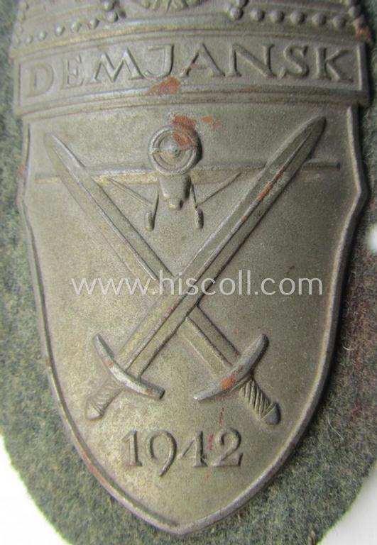 WH (Heeres ie. Waffen-SS) 'Demjansk'-campaign-shield as executed in typical magnetic metal (ie. so-called: 'Eisenblech') and that comes in an overall very nice- ie. fully untouched, condition
