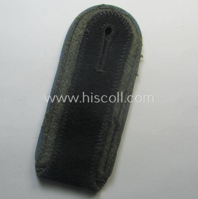 Attractive - albeit regrettably single! - Waffen-SS, EM-type shoulderstrap as piped in the bright-blue-coloured branchcolour as was intended for usage by an: 'SS-Mann' who served within the: 'SS-Nachschub-Trpn.'