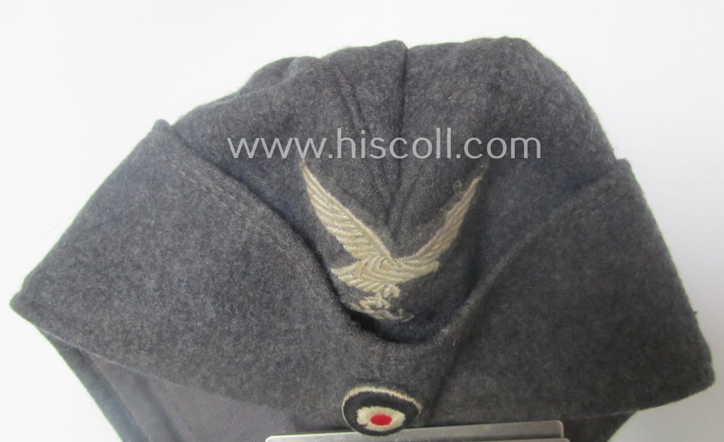 Attractive - albeit moderately used- ie. worn - WH (Luftwaffe) bluish-grey-coloured, EM- (ie. NCO-) type side-cap (ie. 'Schiffchenmütze für Mannschaften u. Unteroffiziere der Luftwaffe')